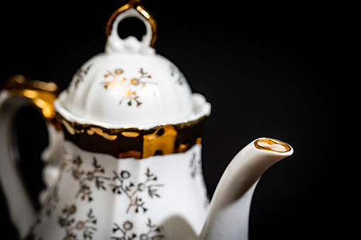 Beautiful ornate tea set kettle and cups with gold leaf design