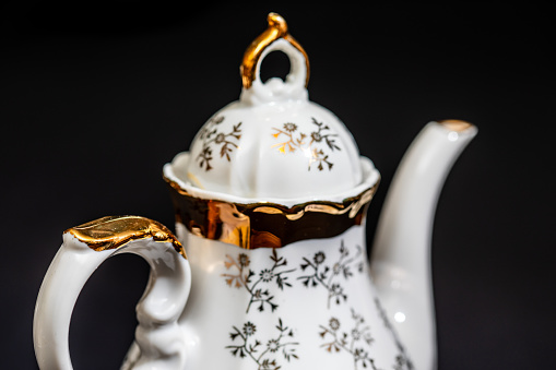 Beautiful ornate tea set kettle and cups with gold leaf design