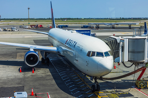 A passenger jet taxis towards an airport gate after landing.