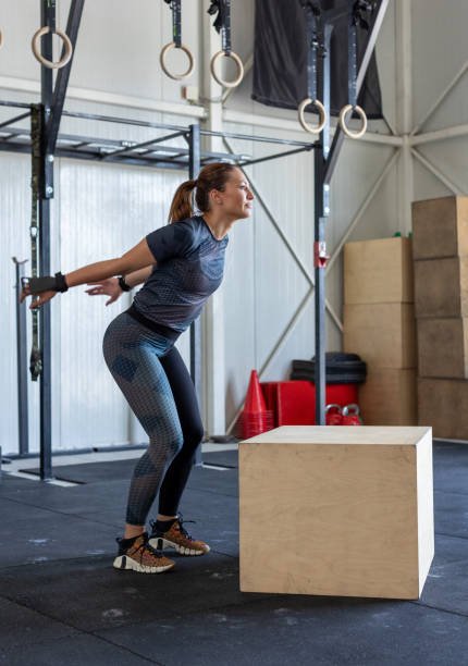 istock Fitness woman doing box jump workout at gym 2000209493
