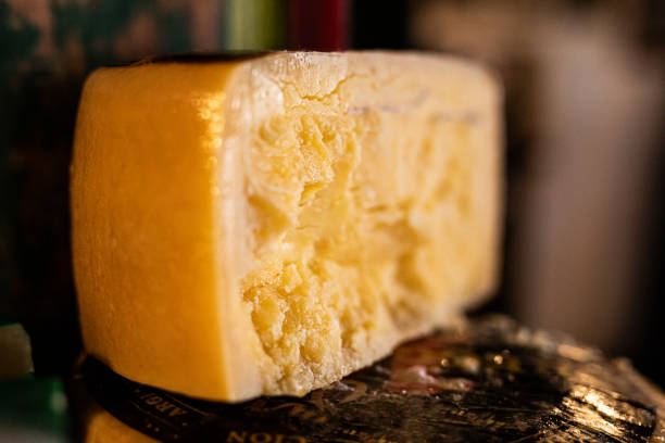 Triangular cheese arranged on a tall wooden tray.