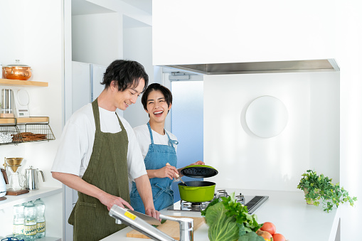 Smiling young couple standing in the kitchen