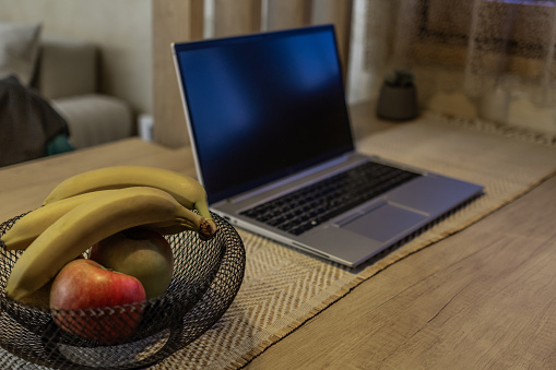 Laptop on kitchen dining table at late night.