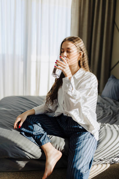 Woman drinking water after wake up