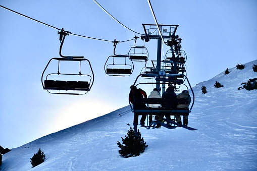Ski lift with people in French alps.