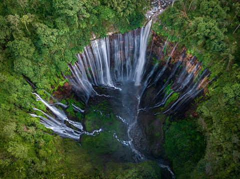 Aerial top view from above of Tumpak Sewu waterfall in Malang, East Java, Indonesia