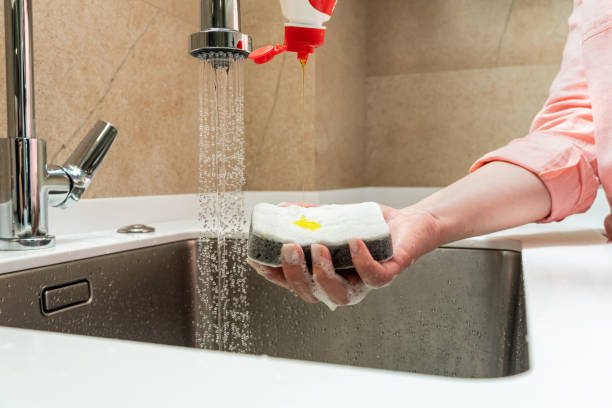istock Dishwashing detergent dripping on the buzzer in hand 2000320870