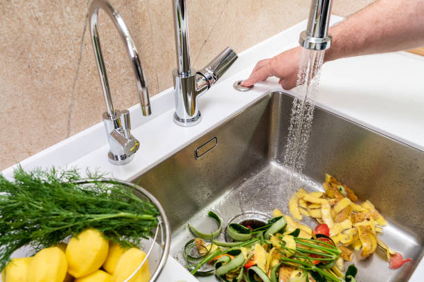 istock Turning on a disposer in a modern kitchen to remove food waste 2000320878