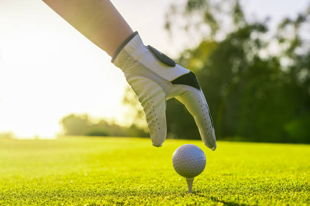 istock Golfer wearing glove placing golf ball on a tee at golf course 2000326736