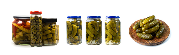 Glass Jars of Pickles such as Cucumbers, Carrot, Onions, Pepper. Marinated and Canned Vegetables Isolated on White Background