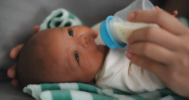 istock Young Asian mother feeding her newborn baby with a bottle 2000344950