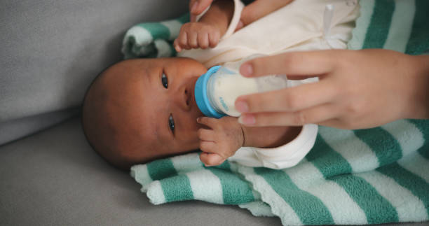 istock Young Asian mother feeding her newborn baby with a bottle 2000347606