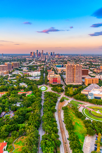 The skyline of downtown Houston, Texas from several miles to the south over Hermann Park shot at dusk via helicopter from an altitude of about 800 feet.