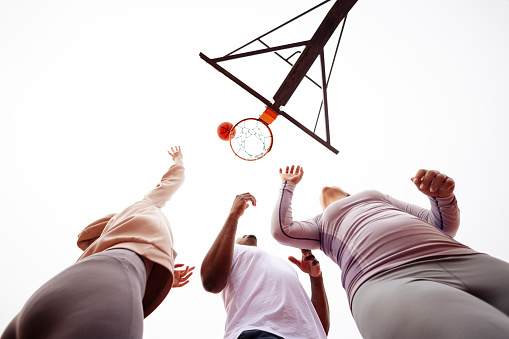 Friends Playing Basketball Outdoors