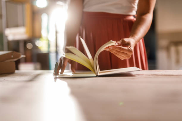 istock Woman flipping pages of her new notebook 2000366998