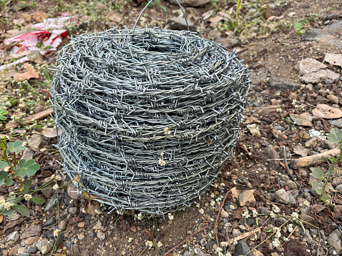 Closeup of barbed wire rolled in circle background.