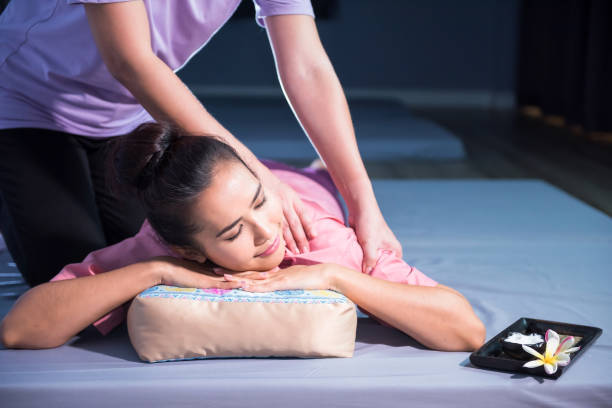 istock Thai shoulder massage on bed by professional masseuse in spa 2000397095