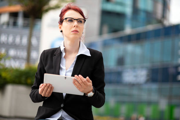 Smiling businesswoman using a digital tablet outdoor - foto stock