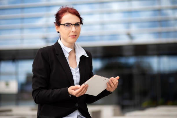 Smiling businesswoman using a digital tablet outdoor