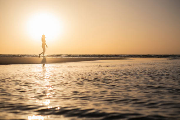istock Woman Stretching on the Beach Sunrise 2000409291