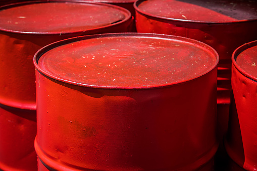The red 55-gallon drums, lined up in rows, serve as vital containers for various industrial liquids