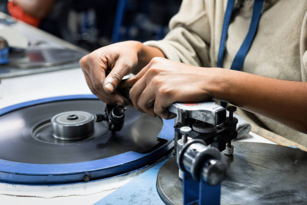 diamond polishers at work at the wheel in the diamond polishing factory - diamond cutting rough gem ストックフォトと画像