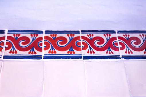 Mexico: Antique Talavera Tiles in White Wall. Shot in Oaxaca.