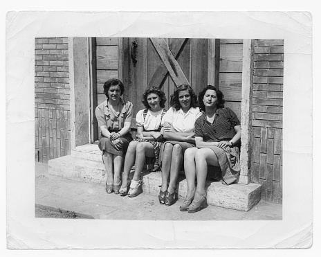 Group of young women sitting on a step. 1941.
