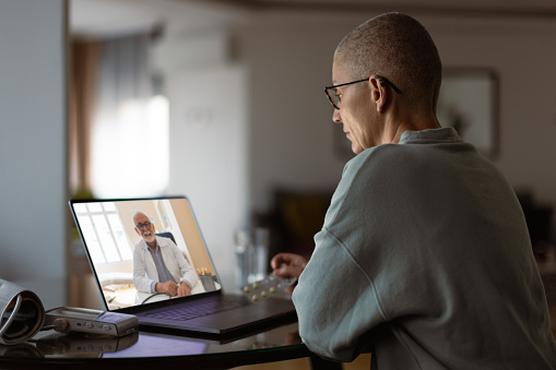 Woman having video call with doctor