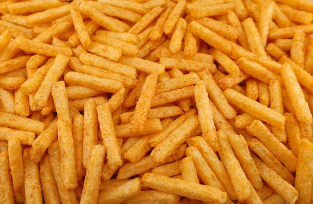 Potato and maize sticks, barbecue flavor snack. Full frame