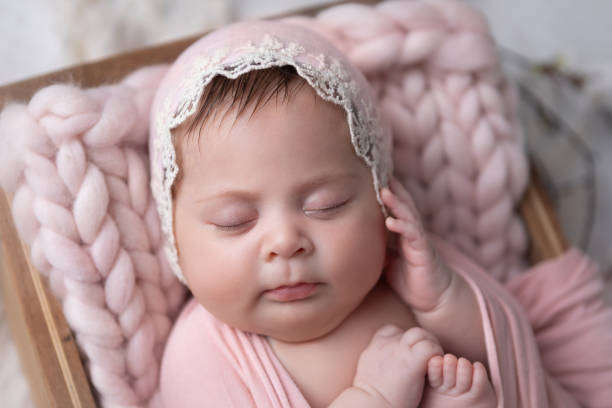 istock Newborn baby girl sleeping in a box 2000475378