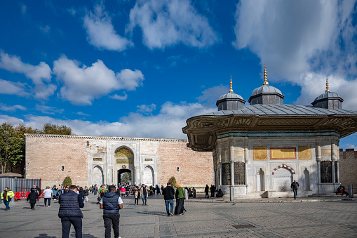 Topkapi Palace to Istanbul, Turkey; November 16, 2023: Picture of the Gate of Salutation in Topkapi Palace in istanbul, Turkey. The Topkapı Palace or the Seraglio, is a large museum in the east of the Fatih district of Istanbul in Turkey. From the 1460s to the completion of Dolmabahçe Palace in 1856, it served as the administrative center of the Ottoman Empire, and was the main residence of its sultans until the 17th century.