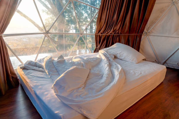 istock White bed inside a large and luxury tent, camping tent with bed. 2000483860