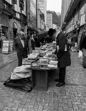 Bogota Colombia 10 de Noviembre del 2023: Man reading books at a flea market