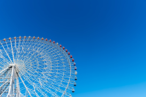 Ferris wheel, colorful big wheel on blue sky. Tempozan ferris wheel Osaka city Japan.