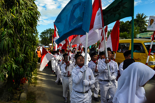 Sorong, Southwest Papua, Indonesia, August 17th 2015. The carnival held in town to celebrate indonesian independence day. People waving the red and white flags.