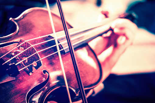 Creative image of a woman playing a viola.