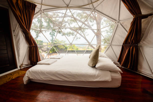 istock White bed inside a large and luxury tent, camping tent with bed. 2000493879