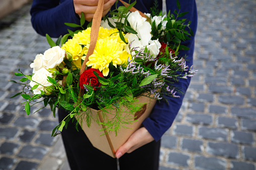 A persons hands hold a beautiful bouquet of flowers, providing ample space for additional content.
