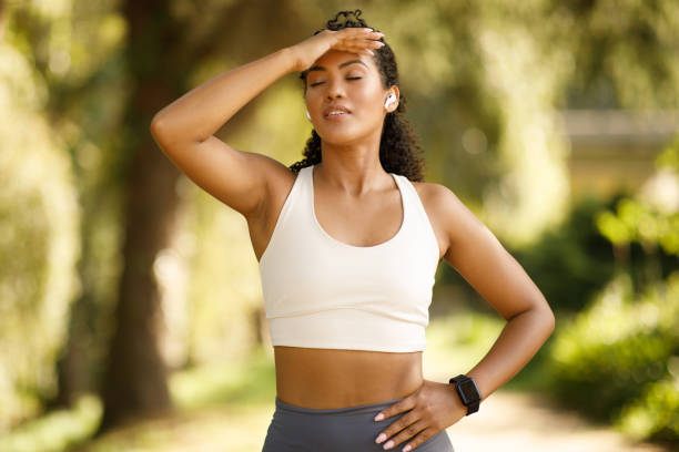 istock sporty woman struggles with exhaustion during marathon training, jogging outside 2000513413