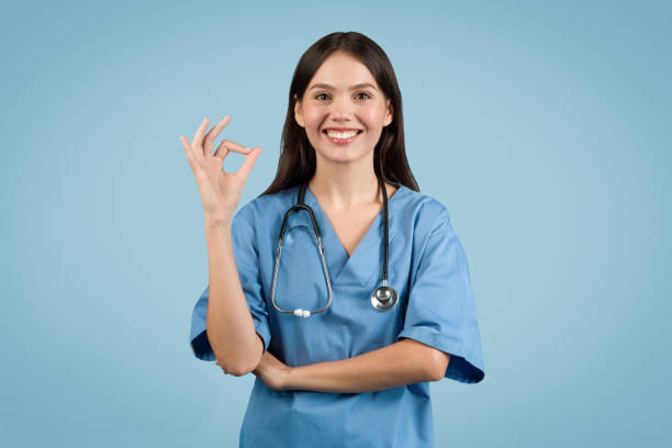 istock Confident nurse in blue gives OK sign, signifying approval or success. 2000519791