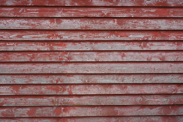 Sky and barn side nostalgic look at rural America. Gabled end of barn building with blazing sun above with copy space.