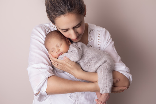 Portrait of mother and newborn baby boy - Mother holding newborn baby son - Buenos Aires. Argentina. Latin America