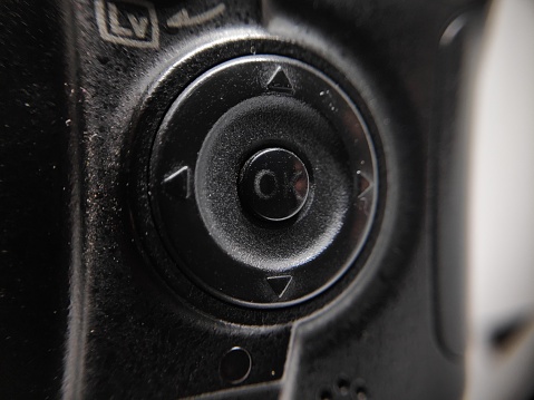 The parts of An old DSLR Camera with black body color completed with its gears. Macrophotography style.