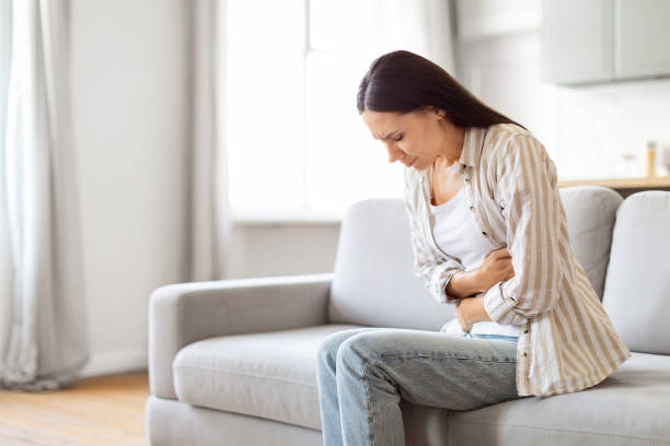 istock Digestion Problems. Sick Young Woman Suffering From Acute Abdominal Pain At Home 2000547788