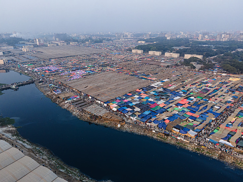 Dhaka, Bangladesh - February 10, 2024: Aerial View of Bangladesh's Biswa Ijtema. Largest peaceful gatherings in the world. Global congregation. Islamic revivalism. World Muslim Congregation, is the world's second largest Islamic gathering after the Hajj with devotees coming from all over the globe to pray and hear imams preach for three days. The huge Ijtema tent on the banks of the River Turag near Dhaka.