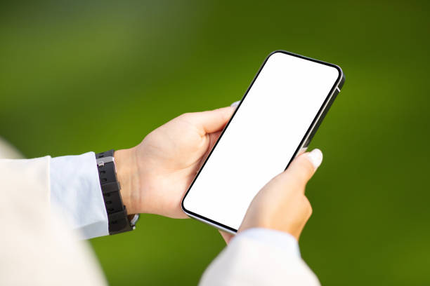 Young european lady typing on smartphone with empty screen in city outdoors, close up