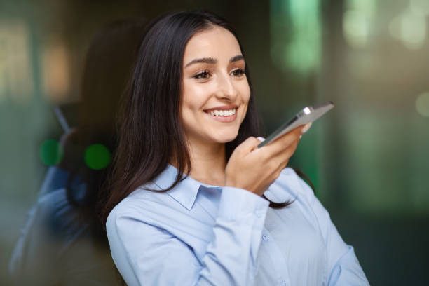 istock Cheerful pretty millennial caucasian lady enjoy work conversation, call by smartphone, talk in city 2000563306