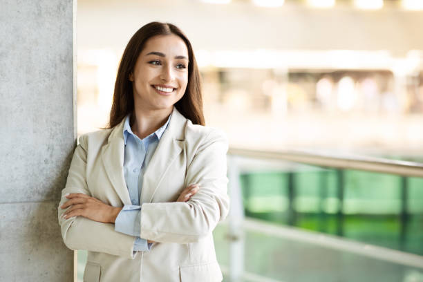 istock A professional young woman with long hair, dressed in a light beige blazer 2000563885