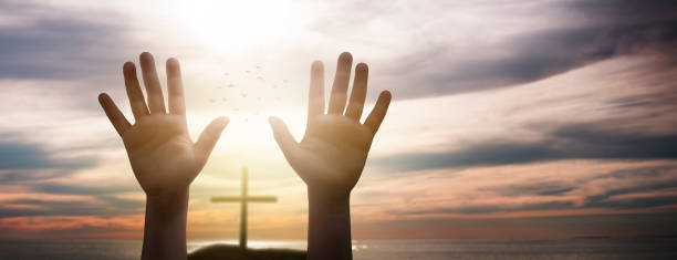 istock child raising hands - concept of hope and asking god for help 2000614976